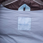 Moncler lining label, white fabric tag with MONCLER text inside the coat
