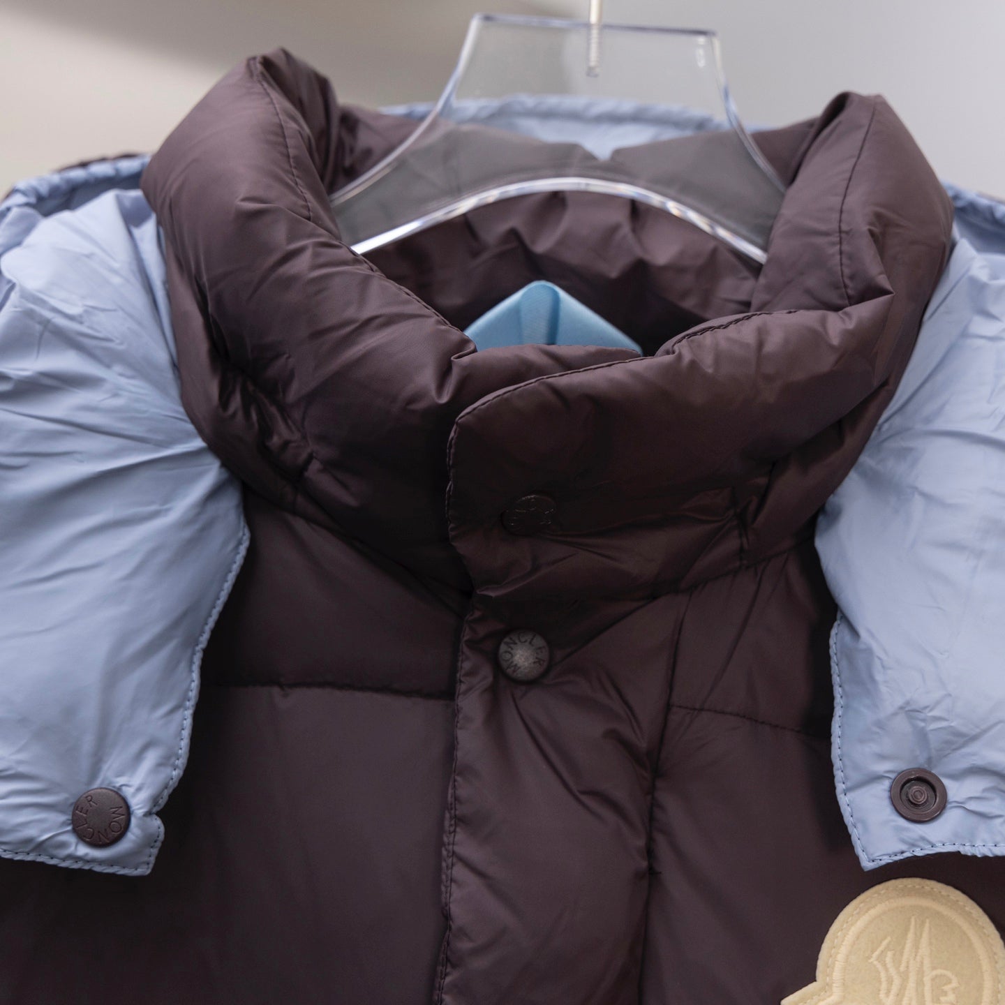 Moncler long puffer coat collar, dark brown padded hood with snaps and light blue trim