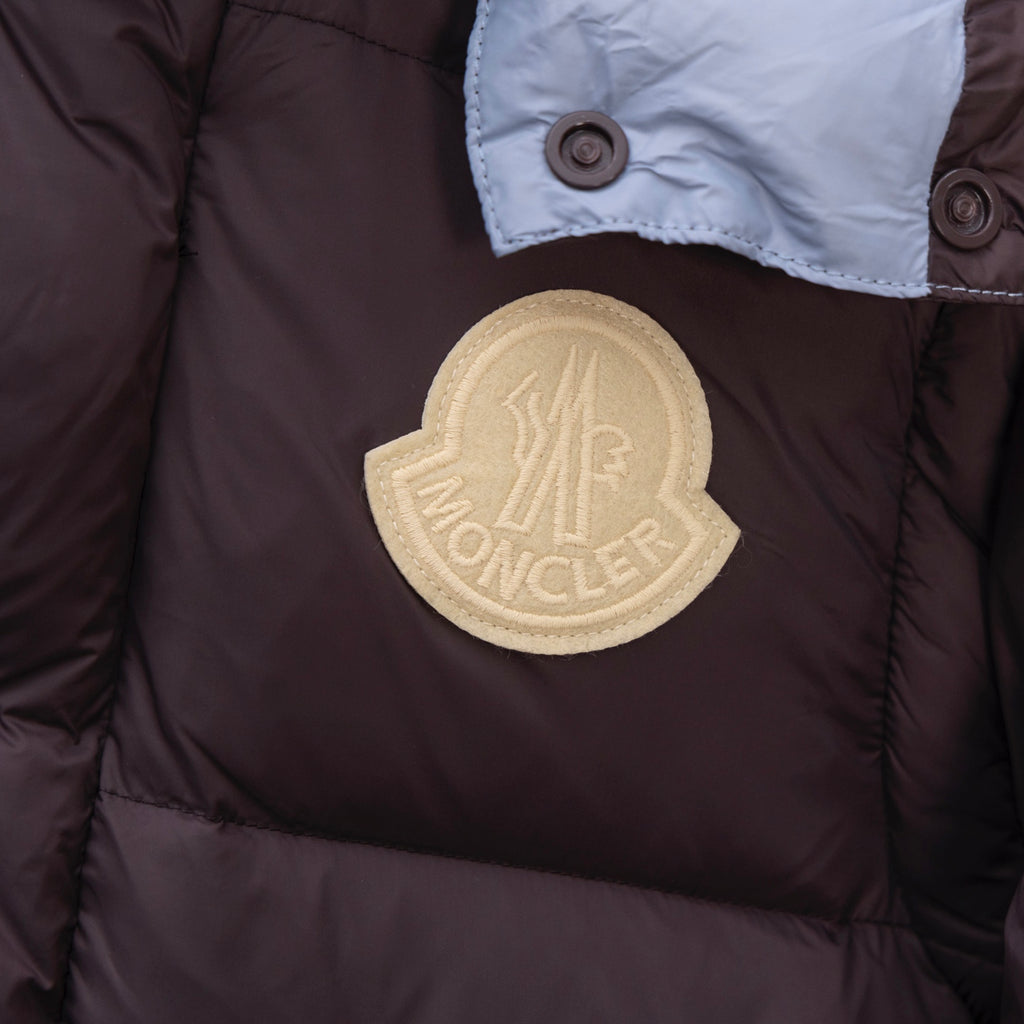 Moncler long puffer coat round gold logo patch on dark brown fabric
