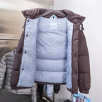 Moncler long puffer coat interior view, light blue lining with buttoned front