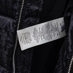 Black Dior puffer jacket care label tag near front zipper.