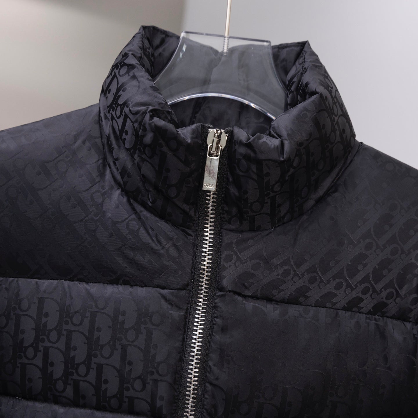 Black Dior long puffer jacket front with zip and monogram pattern.
