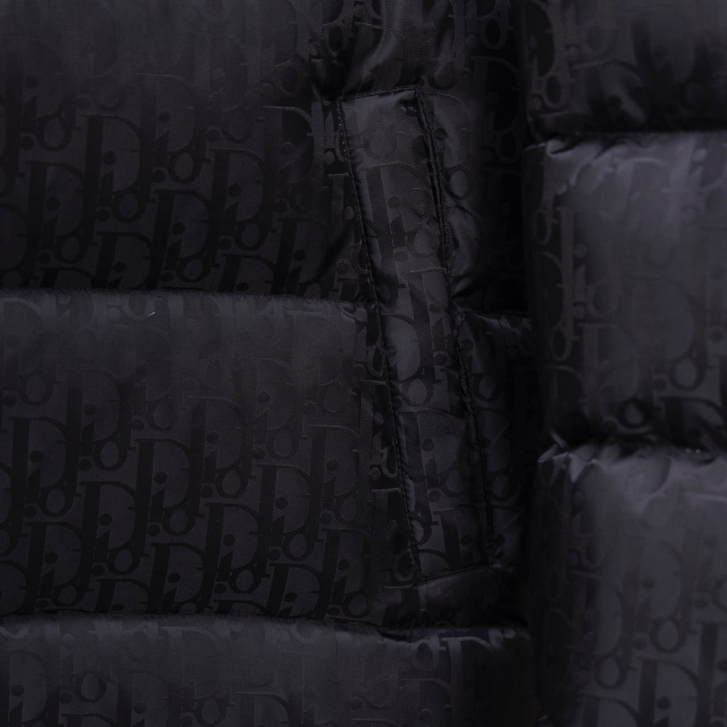 Black Dior puffer jacket front with zipper and monogram pattern close-up.