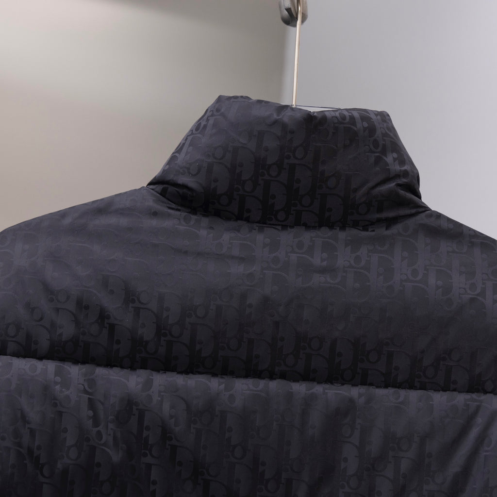 Black Dior long puffer jacket with quilted monogram pattern and hood.