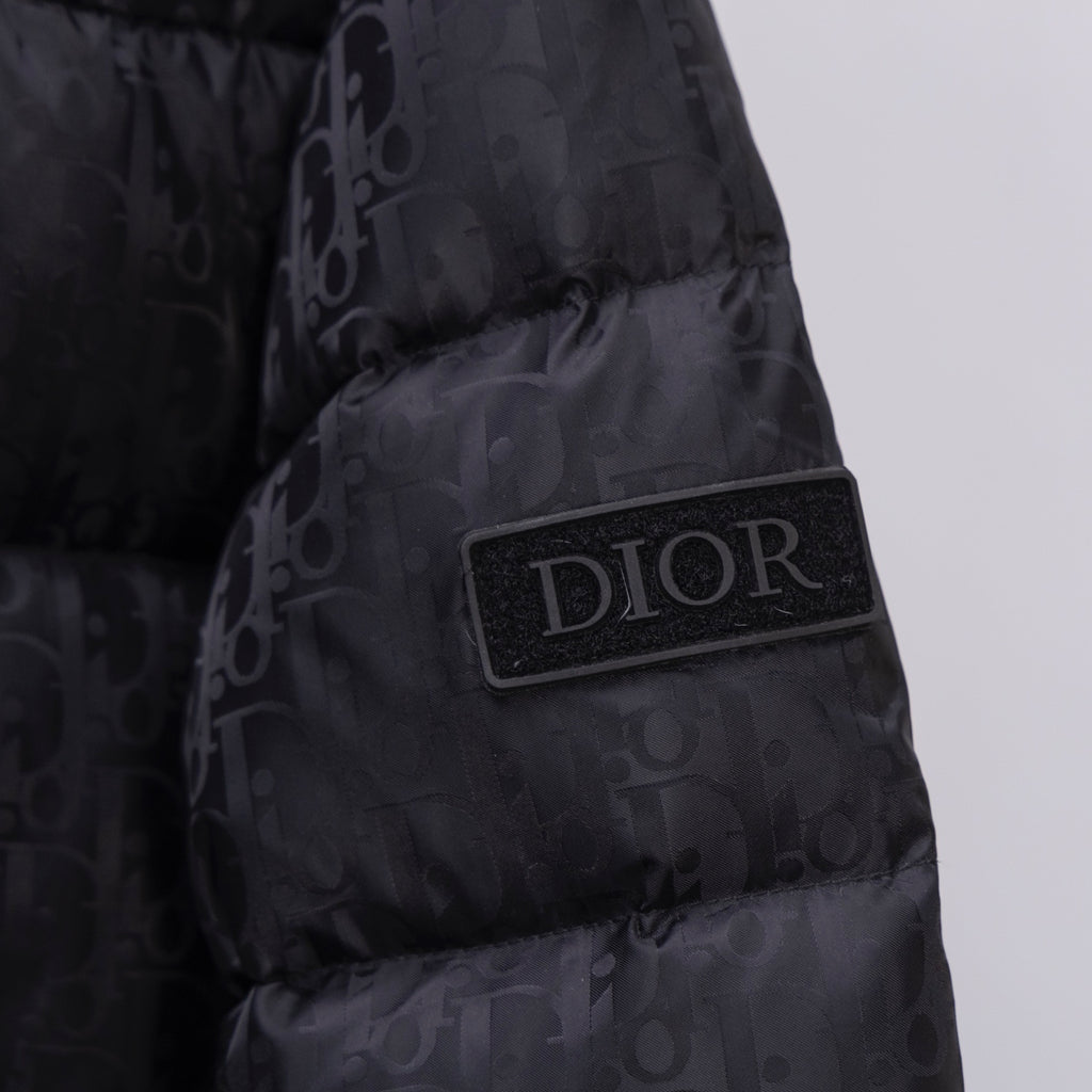 Black Dior puffer jacket chest patch with DIOR logo badge.