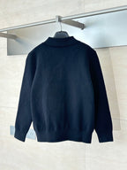 Dark navy zip-up jacket with point collar and subtle monogram pattern