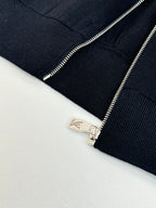 Dark navy knit jacket zipper pull and silver-tone zipper hardware