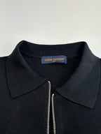 Dark navy zip-up jacket neckline with point collar and partial zipper