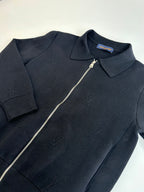 Dark navy zip-up jacket top section with point collar and silver zipper pull