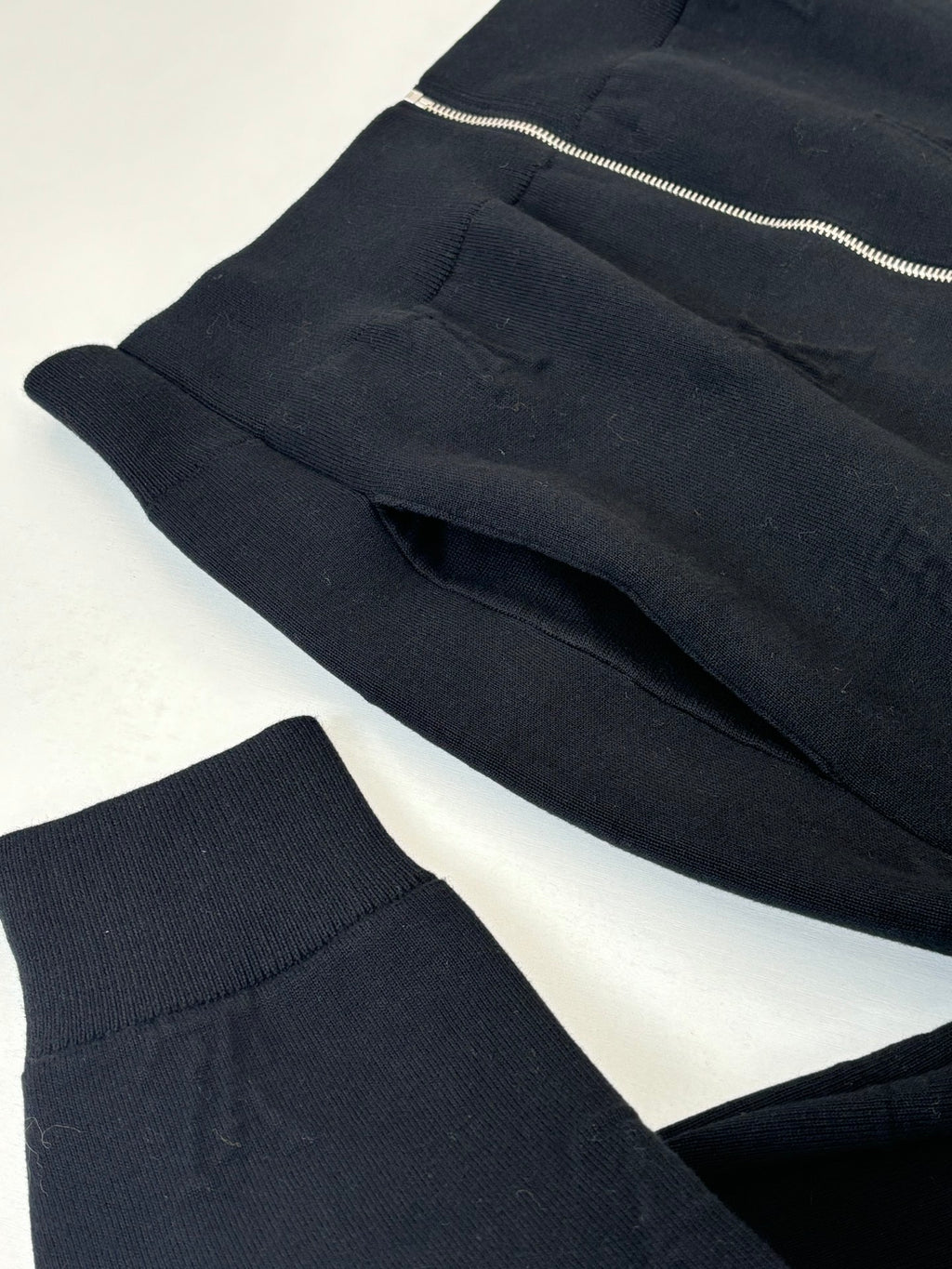 Dark navy knit jacket front panels with ribbed hem and zipper at top edge