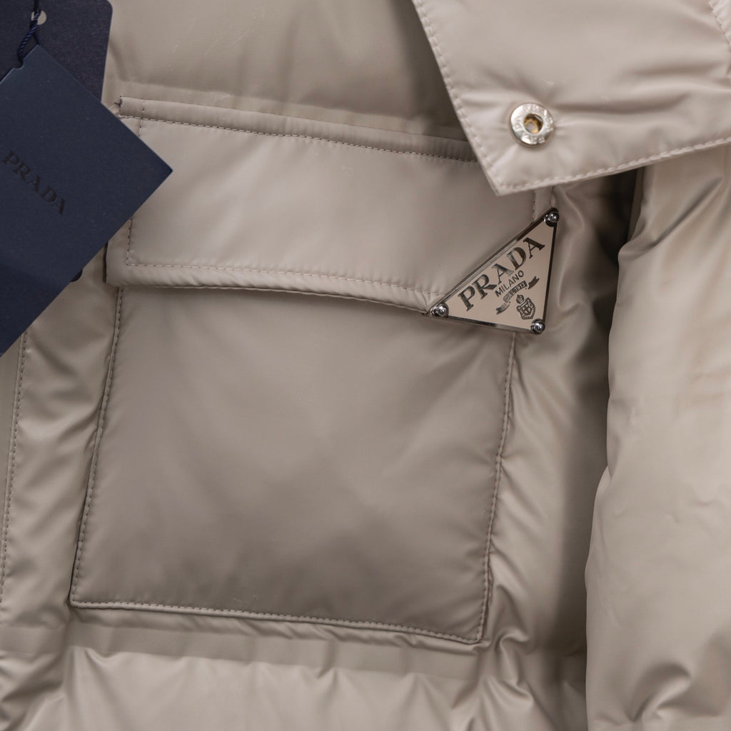Prada puffer jacket chest logo patch on quilted interior lining