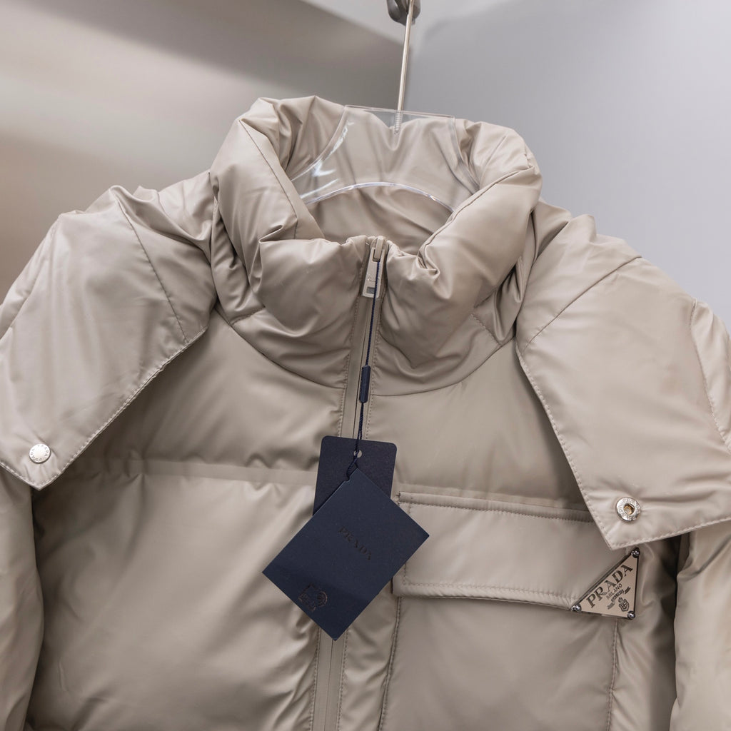 Prada hooded puffer jacket with zip front and brand tag at chest