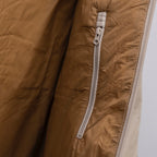 Prada puffer jacket close-up of tan fabric and zip track