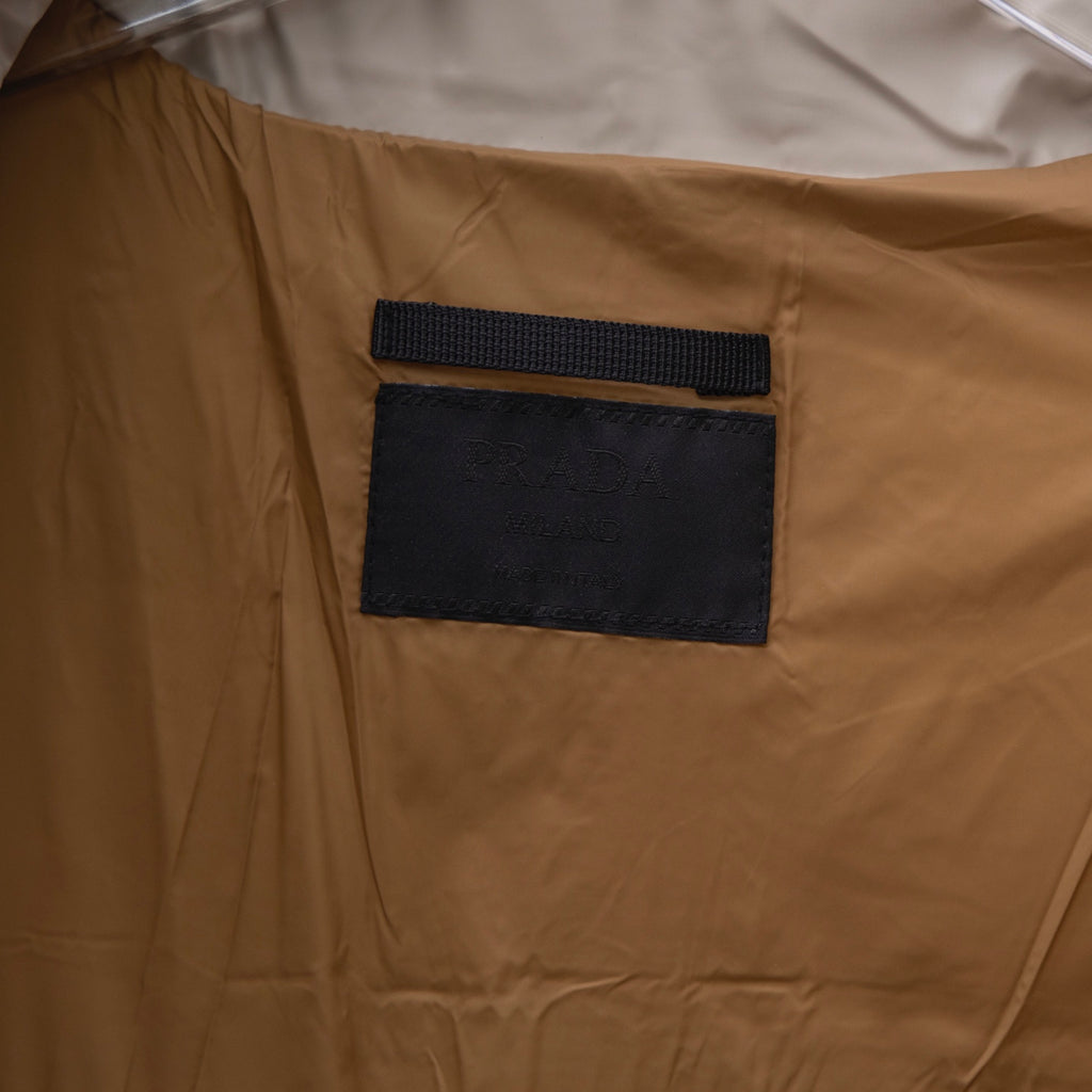 Prada puffer jacket interior fabric with black rectangular label patch