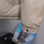 Long coat sleeve cuff in light beige with snap buttons