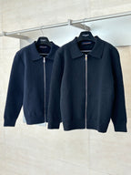 Two dark navy zip-up jackets on hangers, point collar and full-length zipper