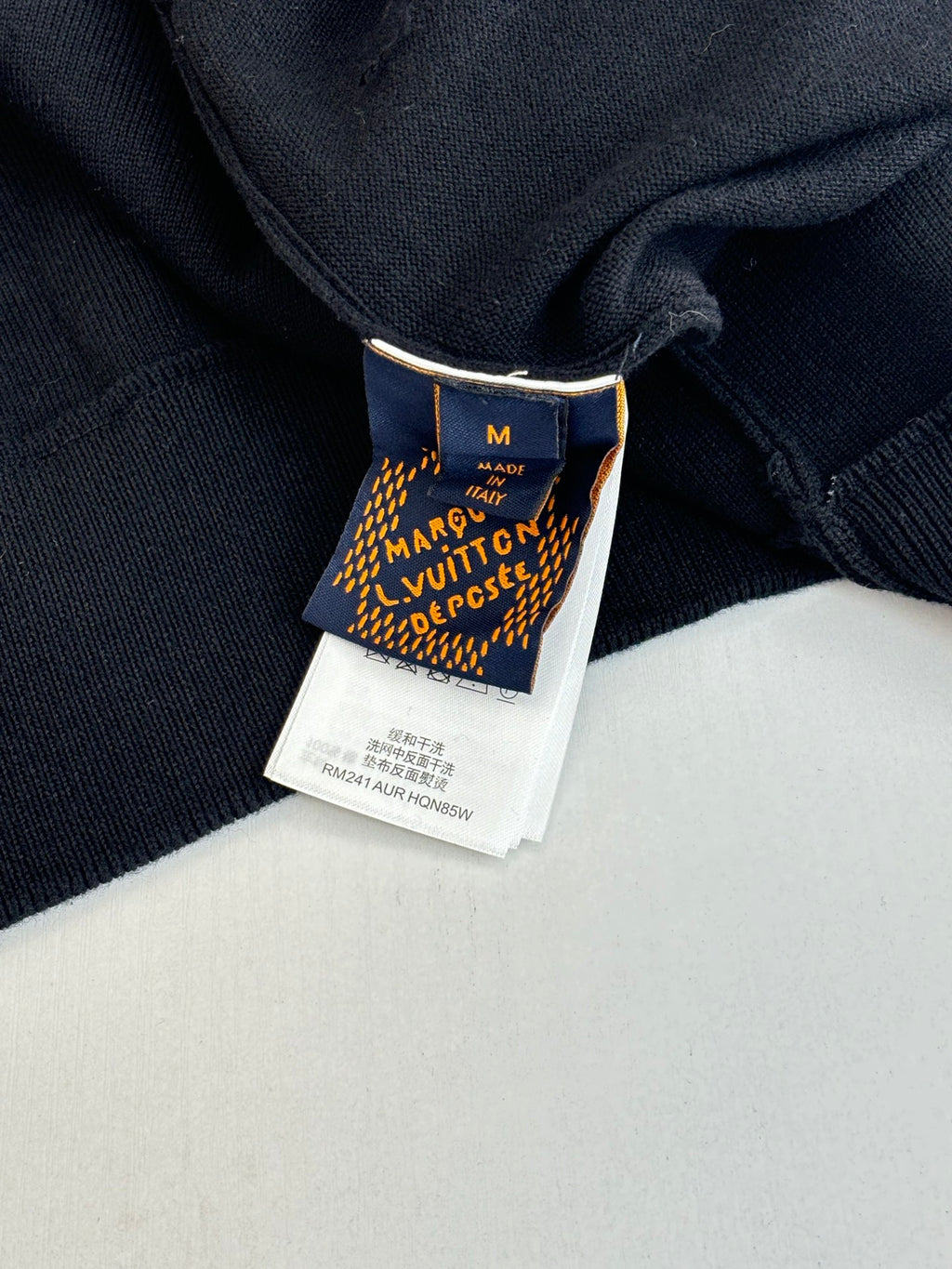 Dark navy jacket interior size tag under the collar seam