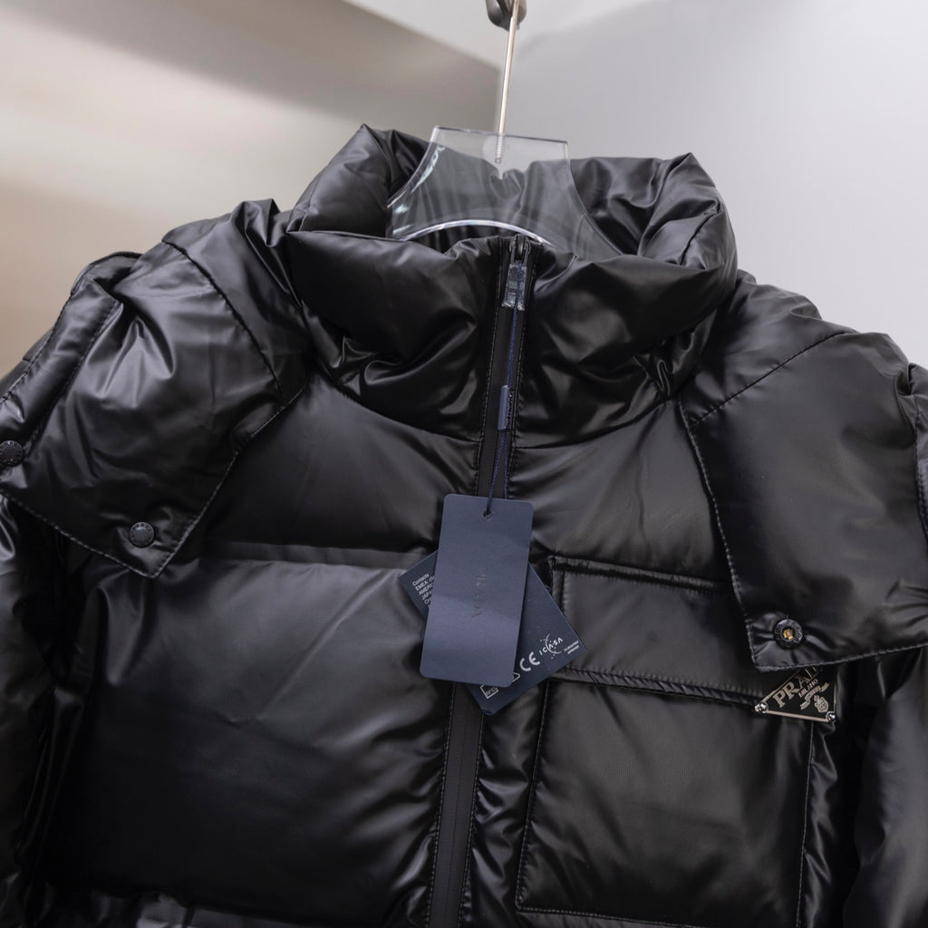 Long puffer jacket in dark, hooded collar with hanging price tag
