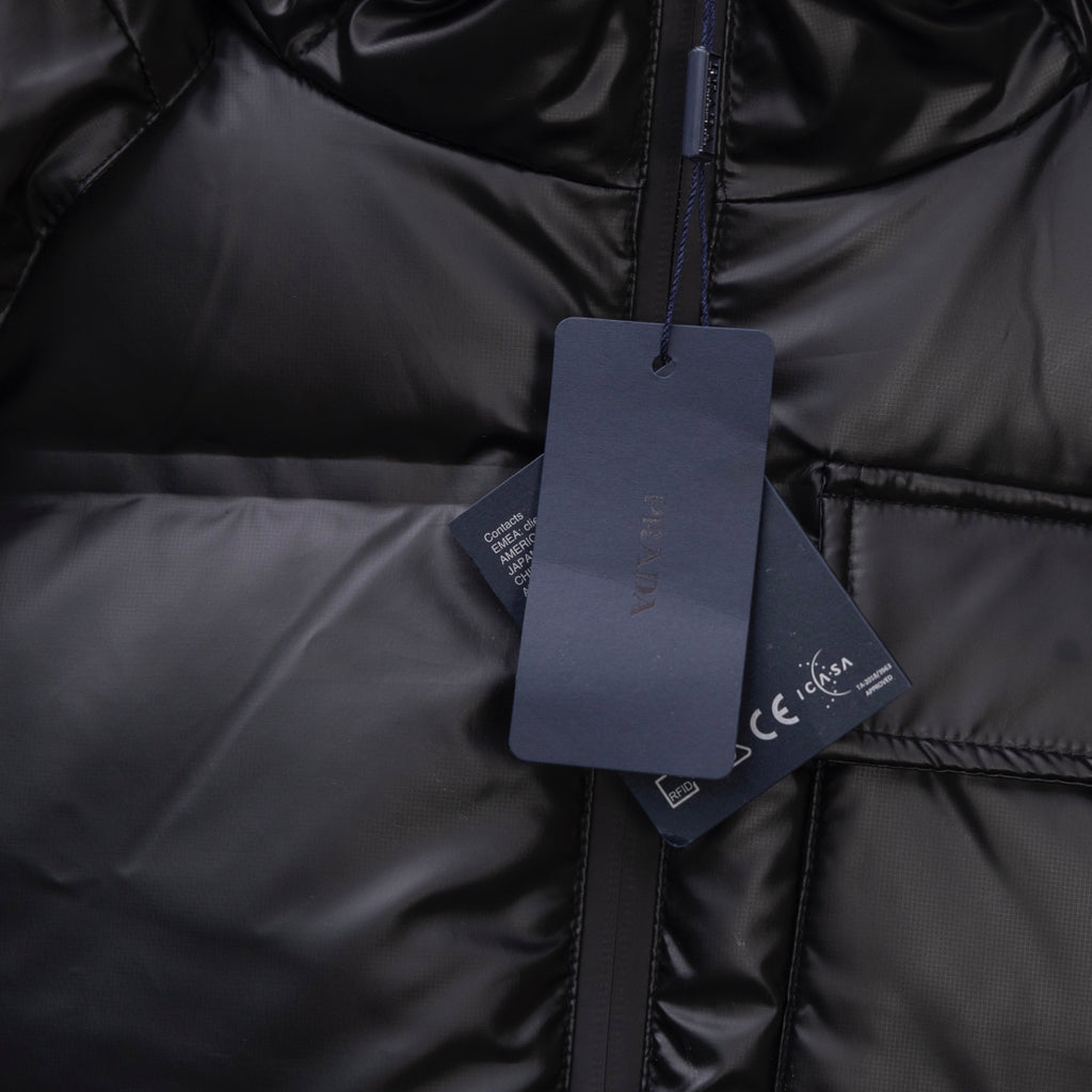 Long puffer jacket, dark front zip with hanging product tag