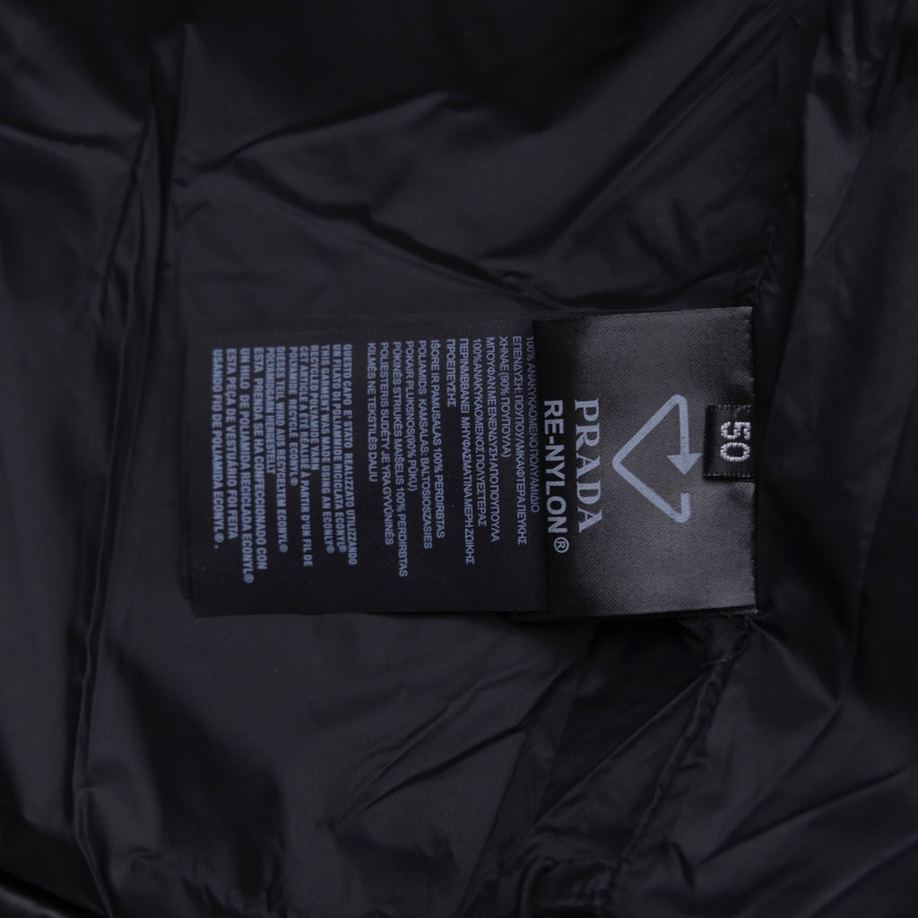 Long puffer jacket interior care label with Prada and size tag