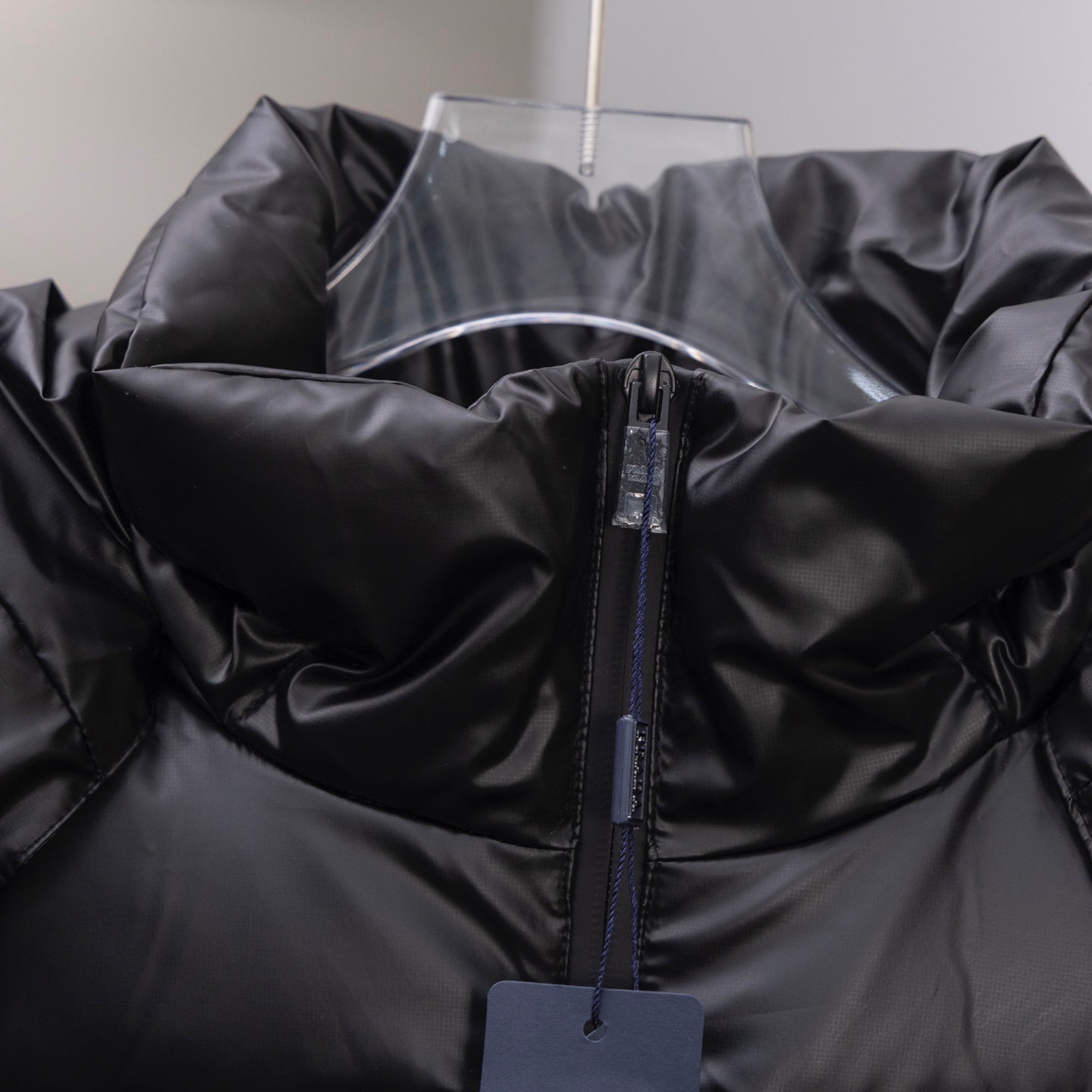 Long puffer jacket, dark with front zipper and quilted panels