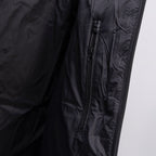 Long puffer jacket close-up of front side zipper on dark fabric
