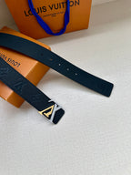 Louis Vuitton belt with dark blue strap and silver LV buckle, laid out