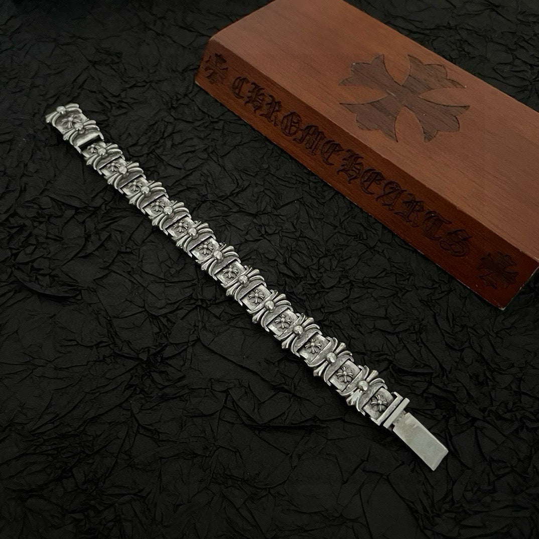Silver-tone bracelet with ornate rectangular link charms and a flat clasp end