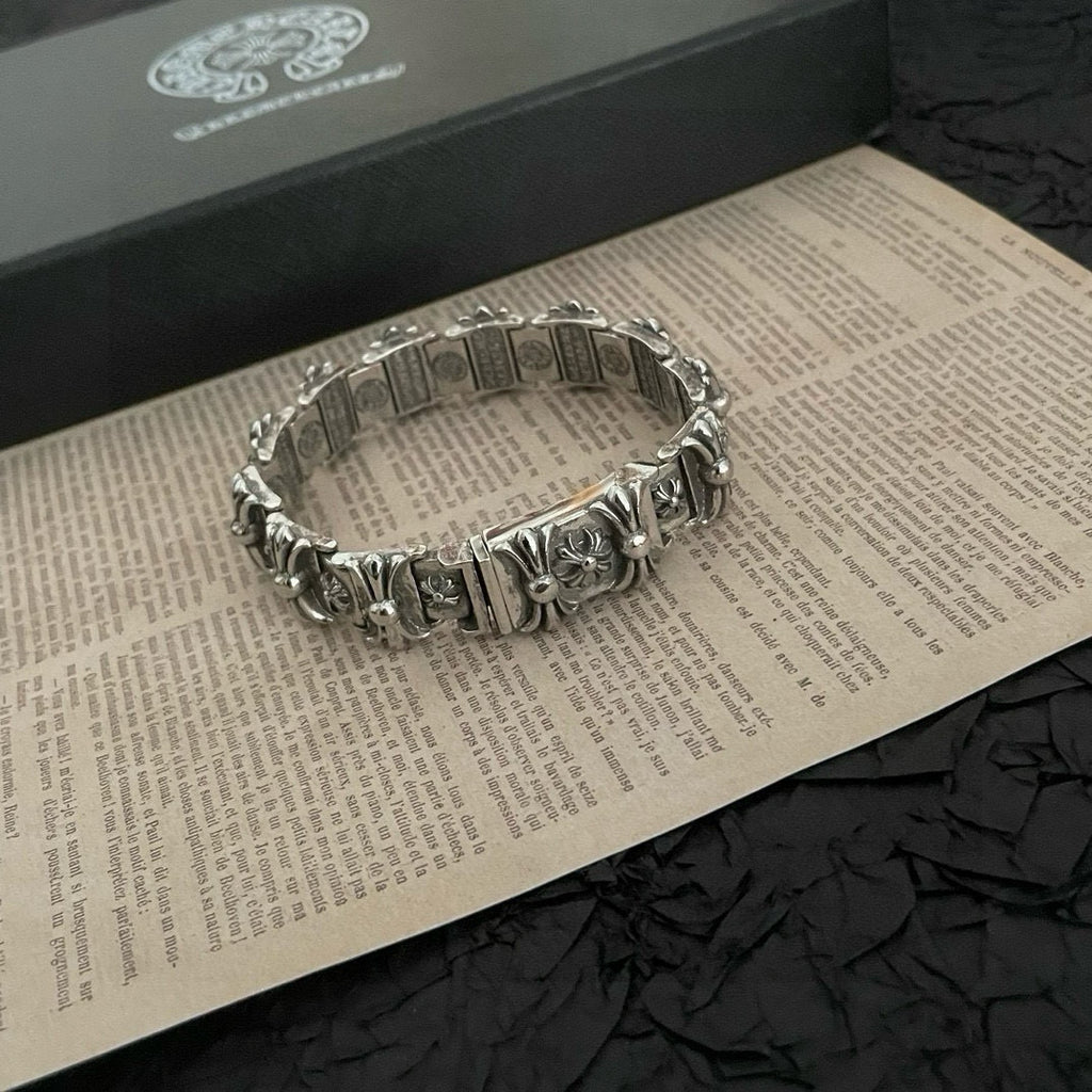 Silver-tone bracelet with engraved rectangular links and floral charms, top view