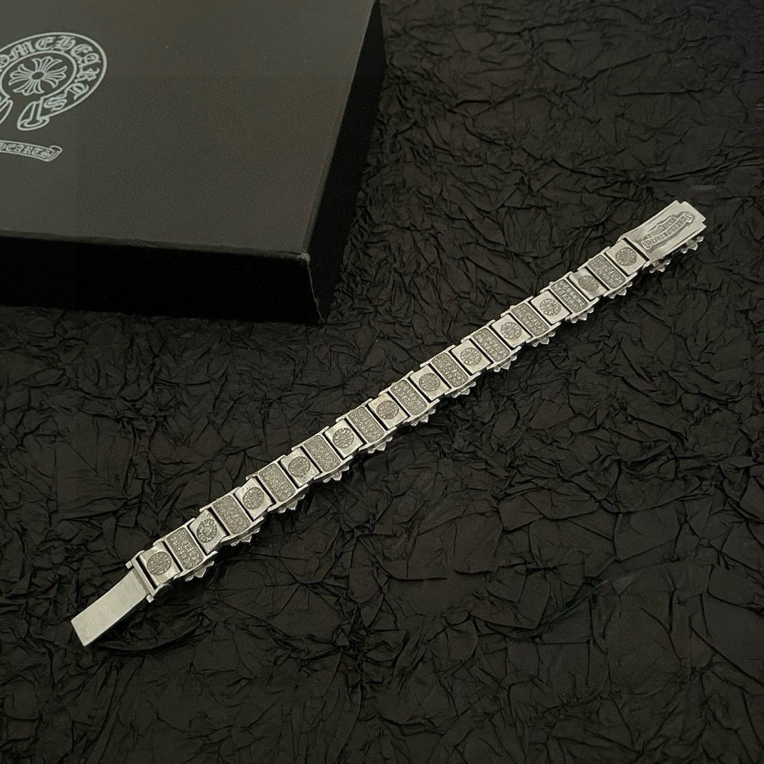 Silver-tone engraved bracelet with rectangular link panels and a bar clasp end