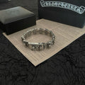 Silver-tone bracelet with engraved rectangular links and floral charm details, round profile