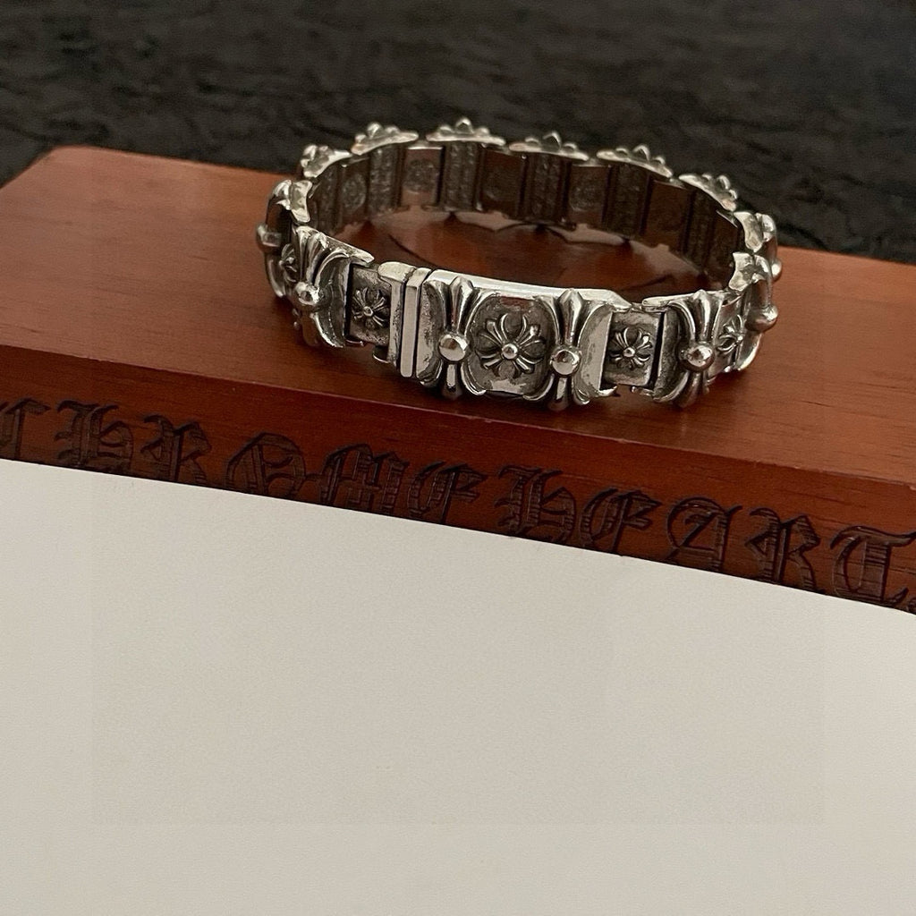 Silver-tone engraved link bracelet with floral motifs and curved ring shape