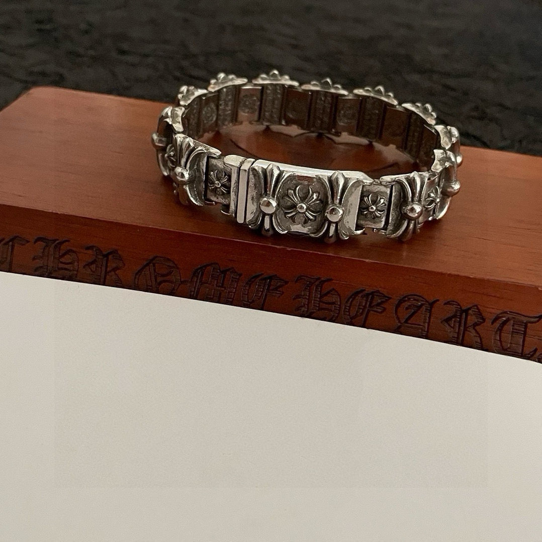 Silver-tone engraved link bracelet with floral motifs and curved ring shape