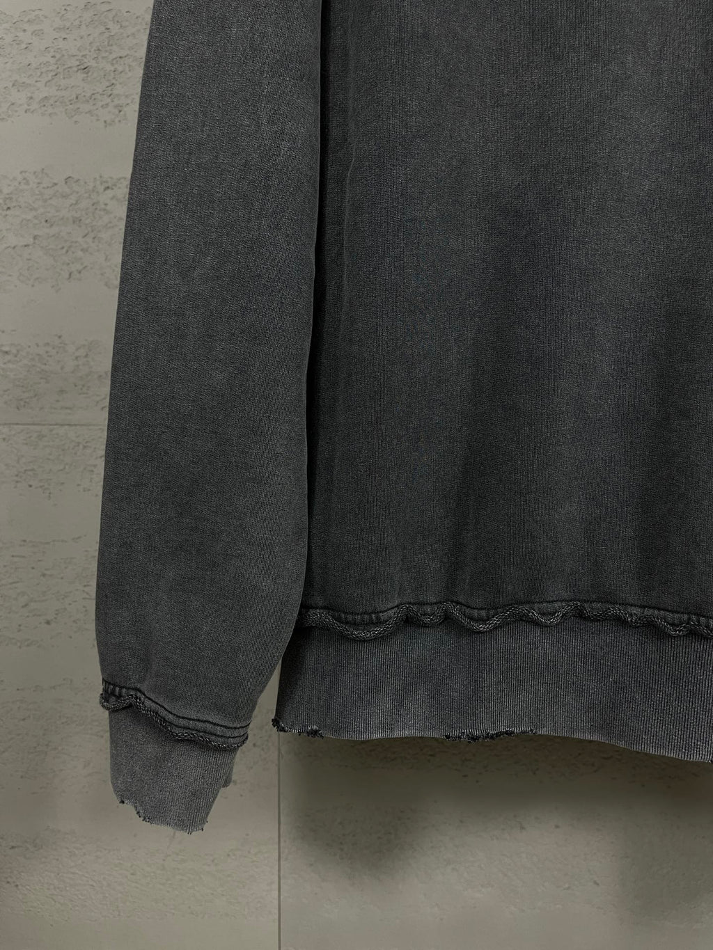 Balenciaga dark zip-up hoodie cuff and hem with slightly distressed fabric