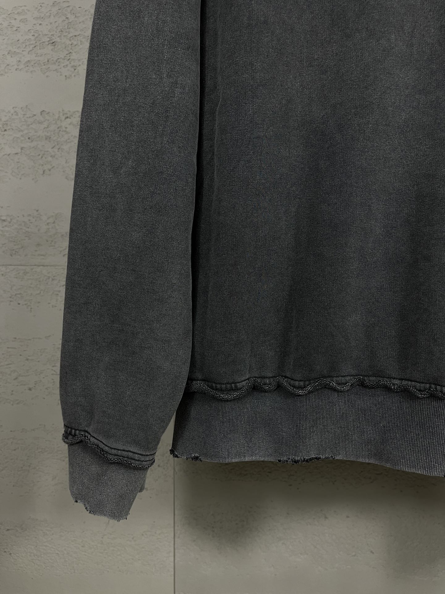 Balenciaga dark zip-up hoodie cuff and hem with slightly distressed fabric
