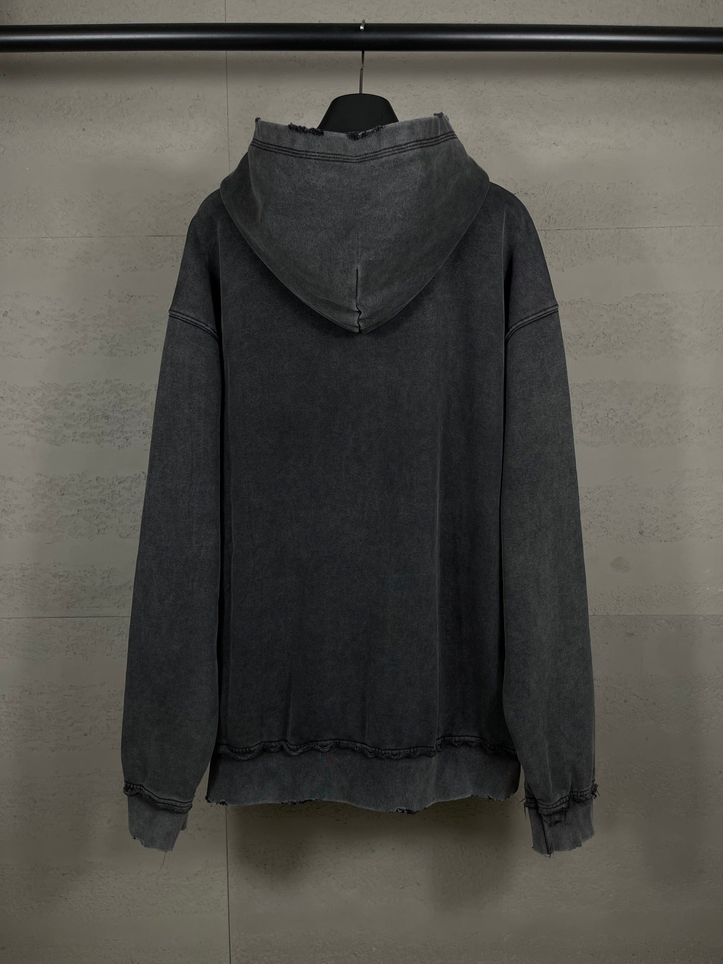 Balenciaga dark zip-up hoodie with hood, back view, ribbed cuffs