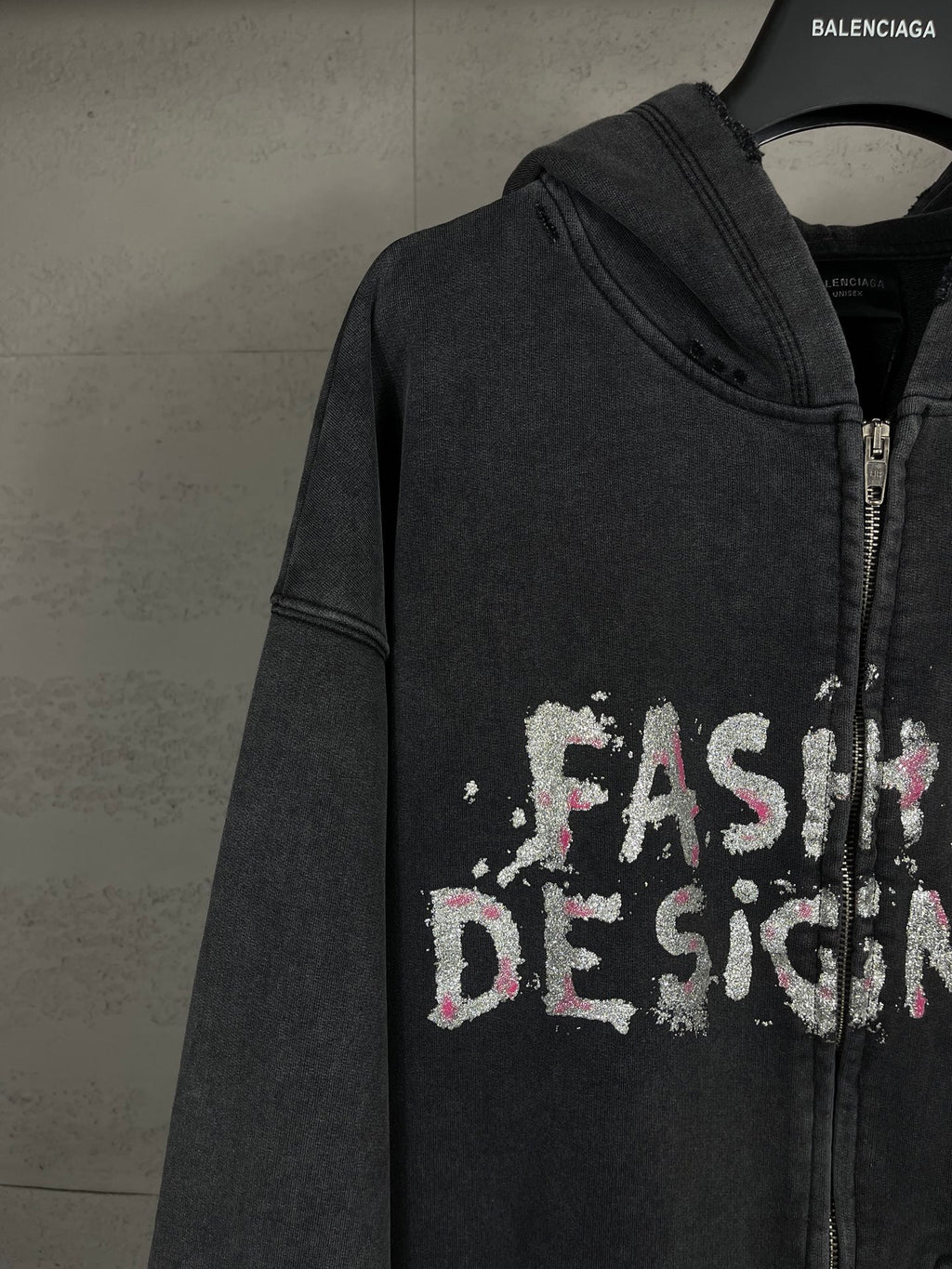 Balenciaga dark zip-up hoodie with hood and 'Fashion Designer' graphic across chest