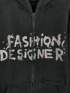 Balenciaga dark zip hoodie close-up: 'Fashion Designer' graphic and front zipper