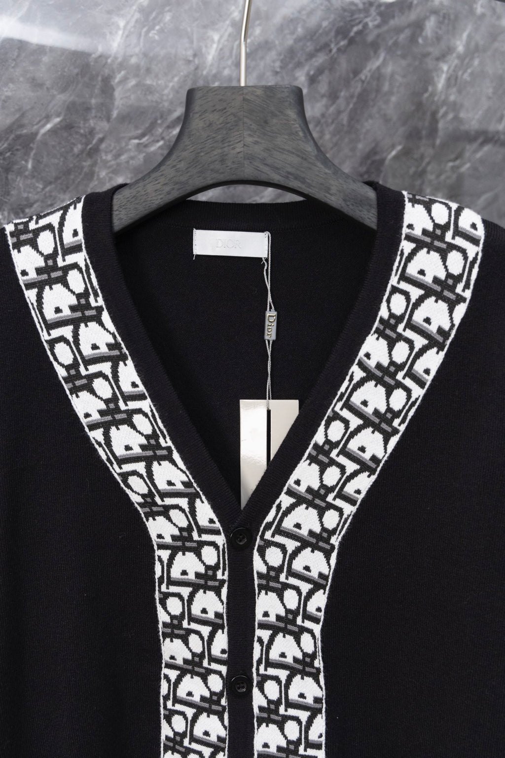 Long black cardigan front with V-neck and white patterned trim at edges