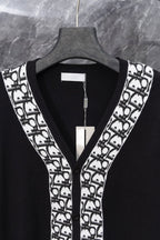 Long black cardigan front with V-neck and white patterned trim at edges