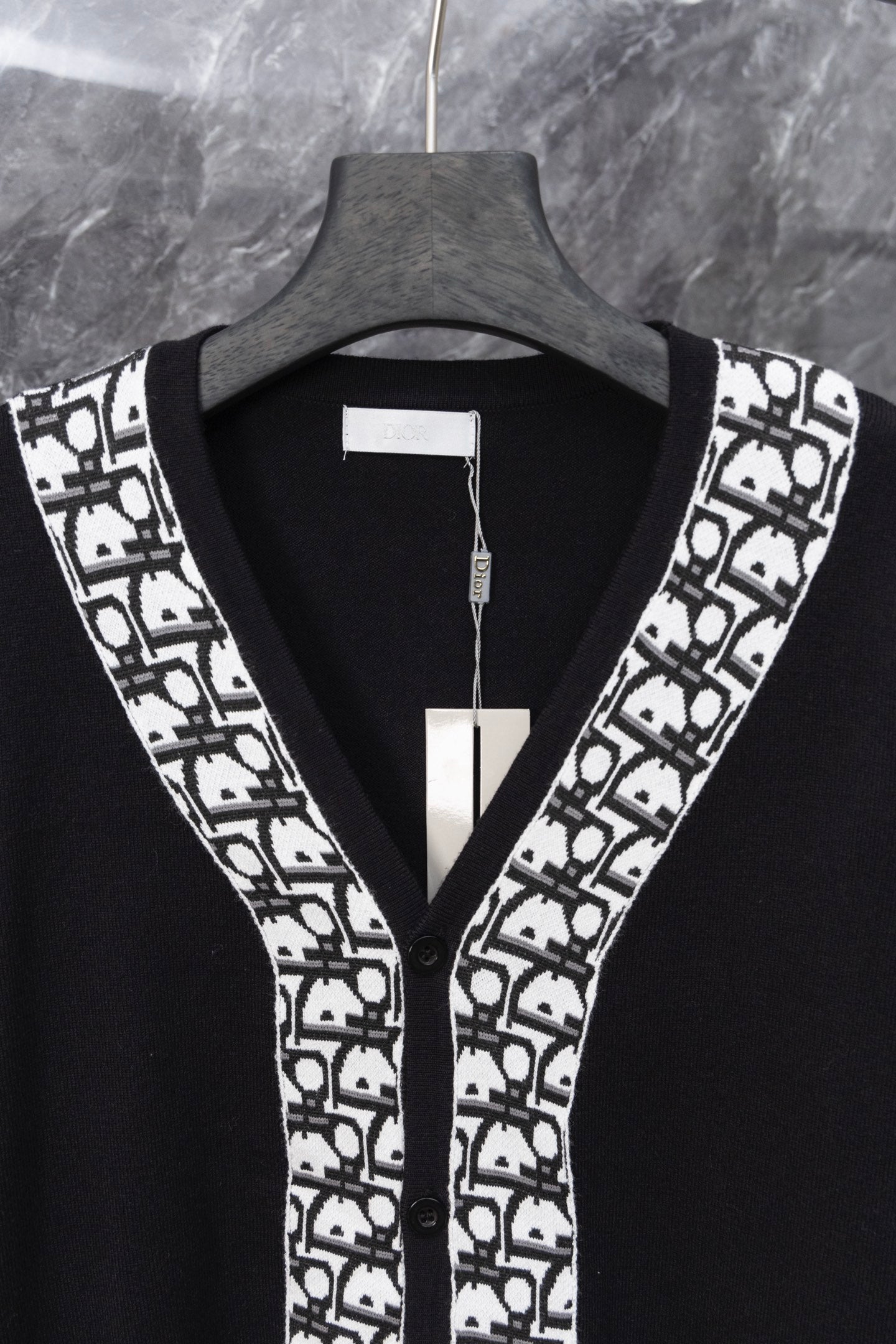 Long black cardigan front with V-neck and white patterned trim at edges