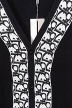 Black cardigan front with white patterned trim and black buttons
