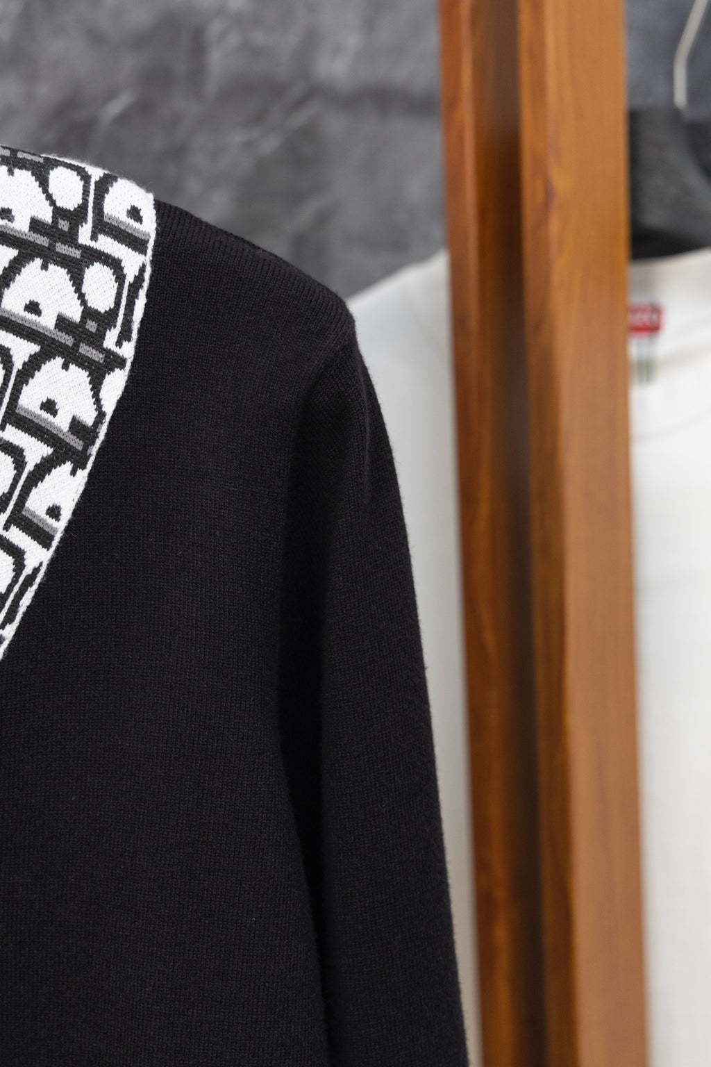 Black cardigan side view with long sleeve and textured knit fabric