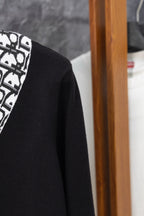 Black cardigan side view with long sleeve and textured knit fabric