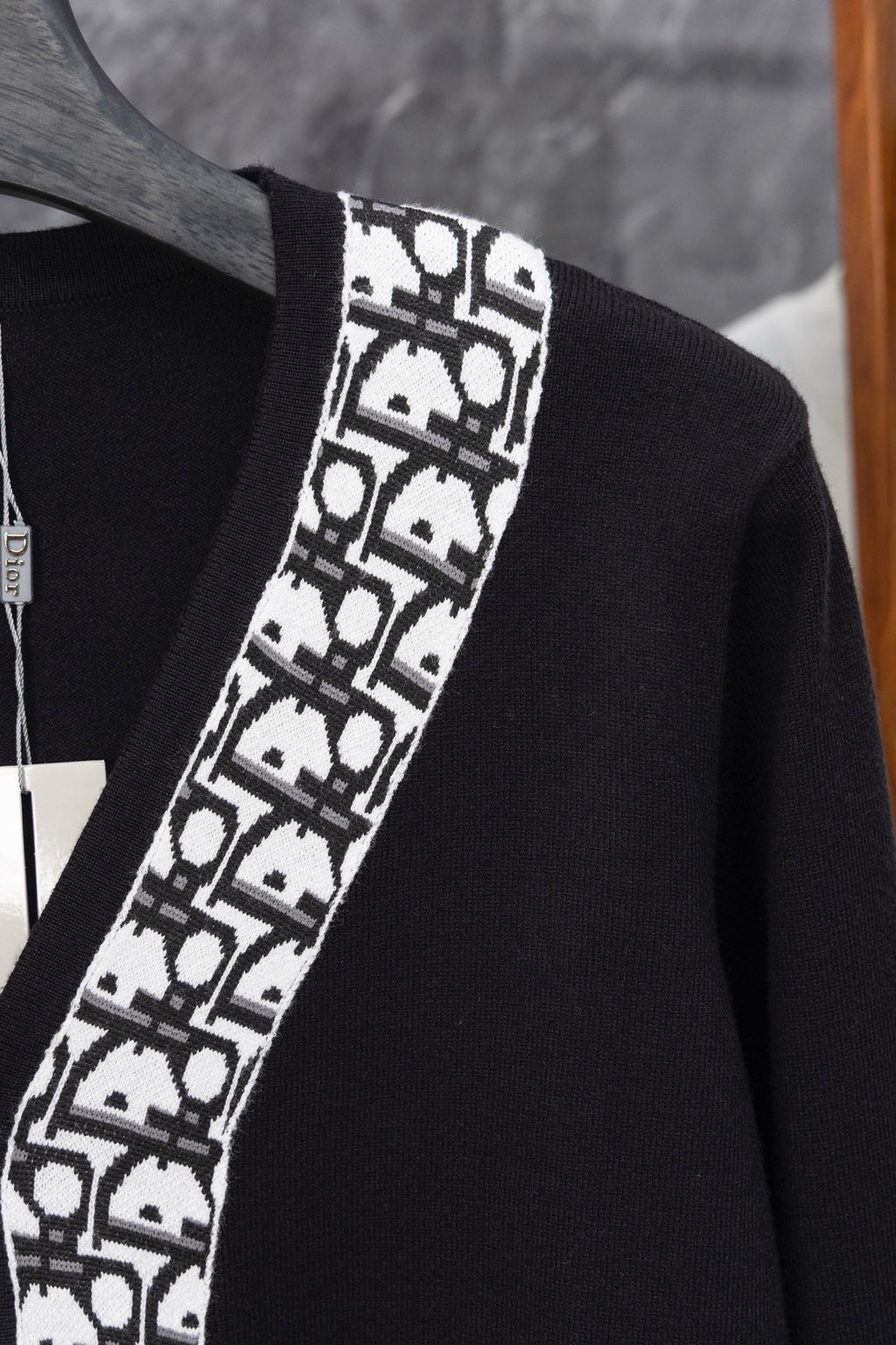 Long black cardigan with white patterned V-edge trim and ribbed neckline