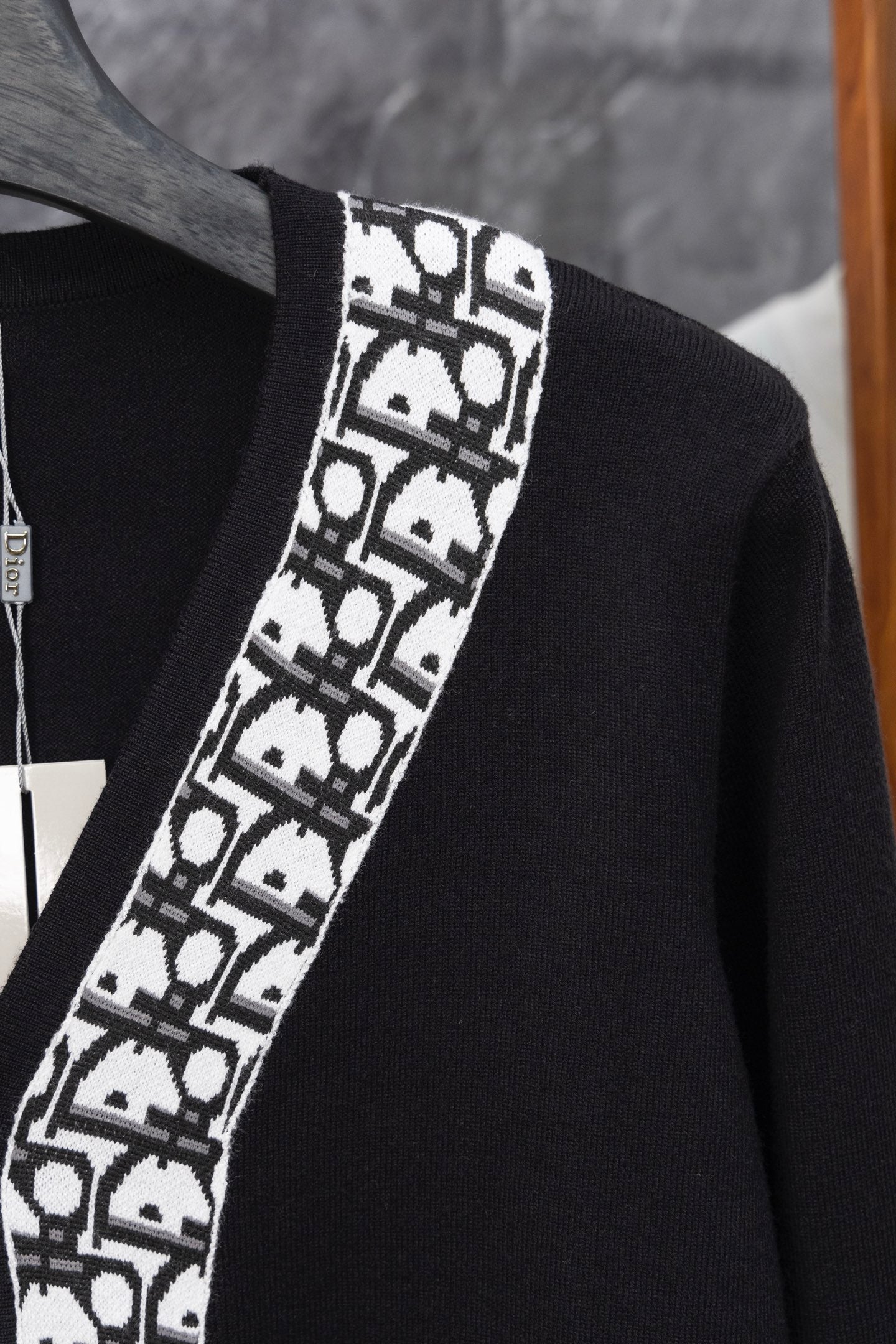 Long black cardigan with white patterned V-edge trim and ribbed neckline