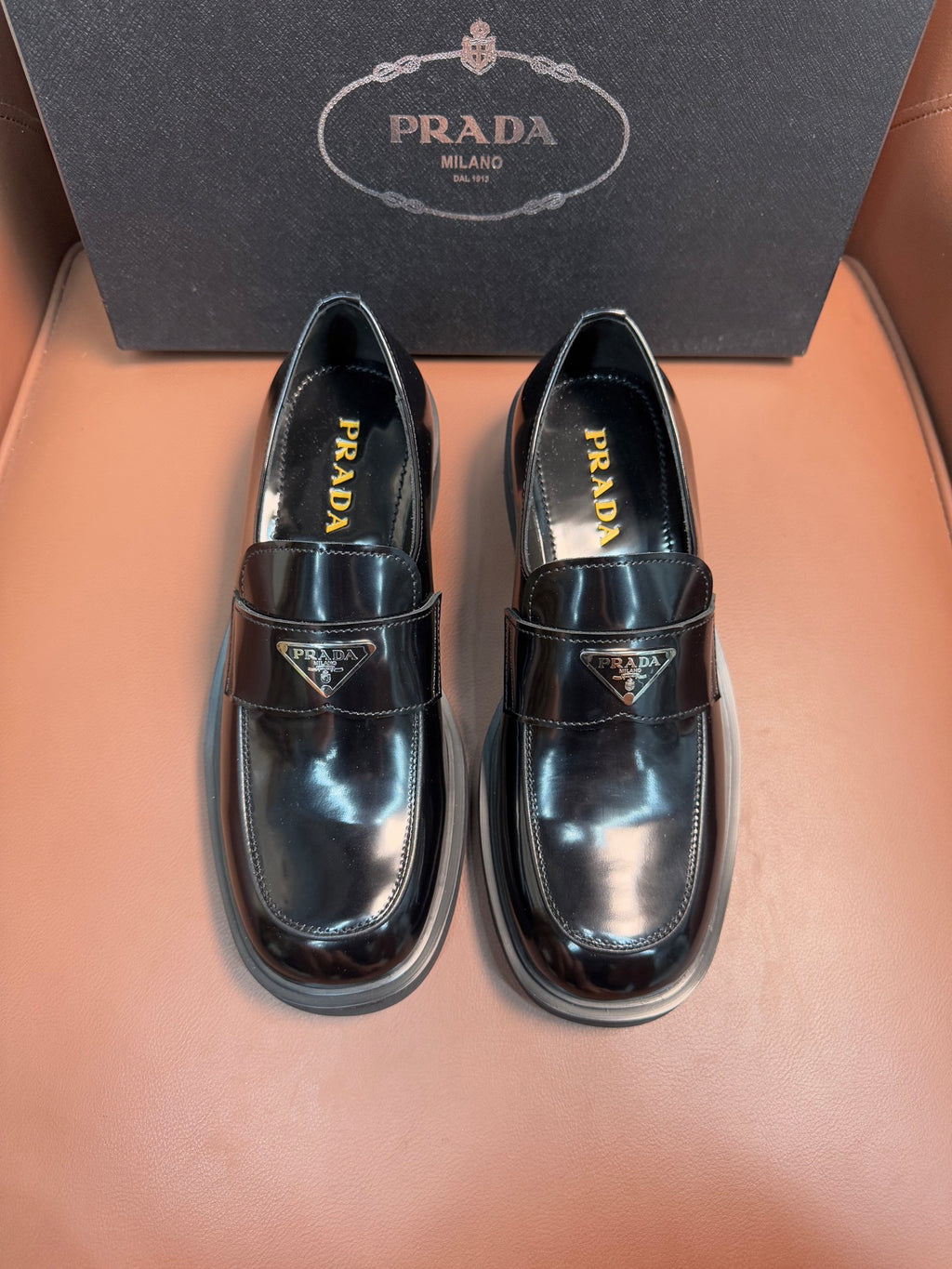 Prada unisex leather loafers, dark glossy finish, buckle strap, low stacked sole