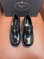 Prada unisex leather loafers, dark glossy finish, buckle strap, low stacked sole