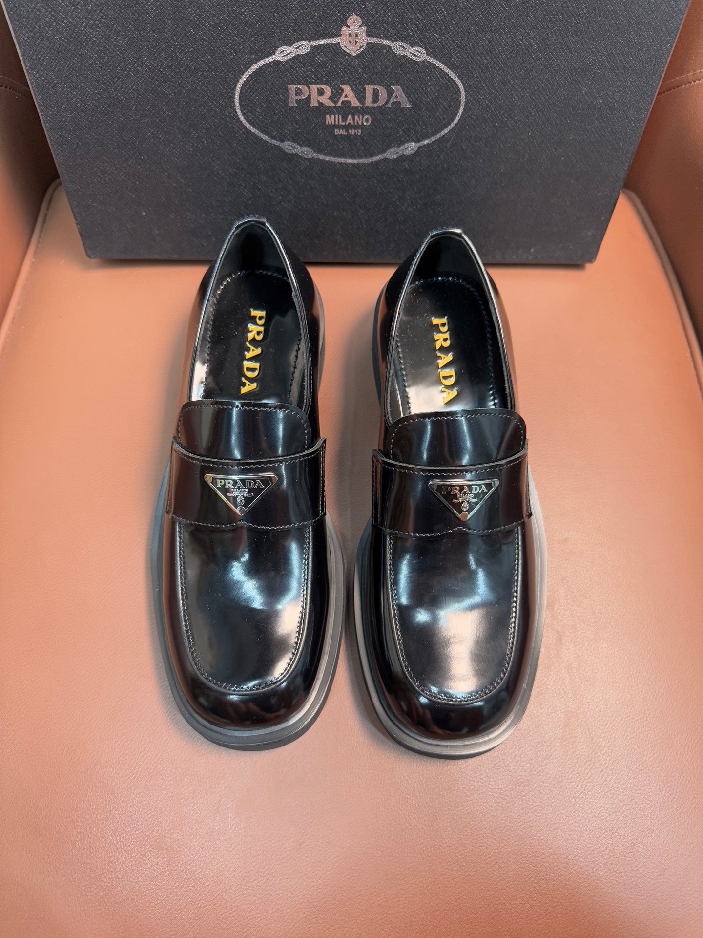 Prada unisex leather loafers, dark glossy finish, buckle strap, low stacked sole