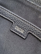 Dior logo patch on textured gray-blue interior pocket